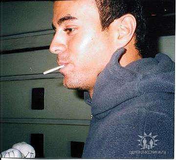 Enrique Iglesias smoking a cigarette (or weed)
