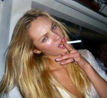 Candice Swanepoel smoking a cigarette (or weed)
