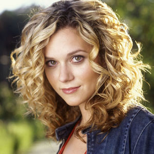 Cabelo castanho claro e penteado com coque de Hilarie Burton  em 2024