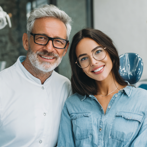 Clinicadentalgranviaalicante-Photo-of-a-dentist-smiling-kindly-next-to-a-sat-324fb02d-82d7-4196-aa1b