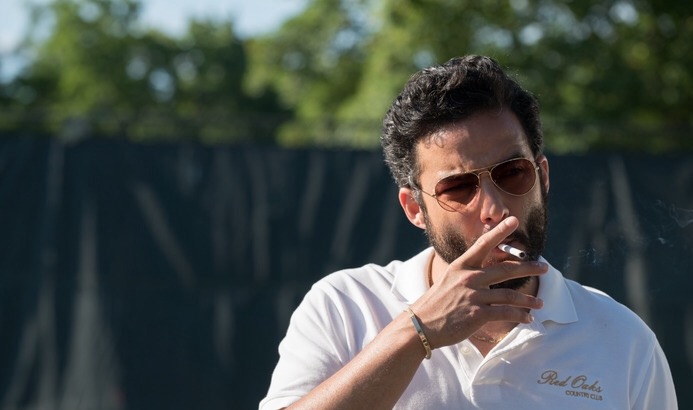 Ennis Esmer smoking a cigarette (or weed)
