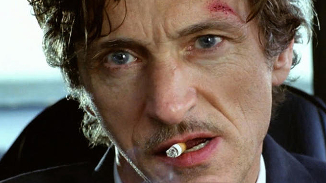 John Hawkes smoking a cigarette (or weed)

