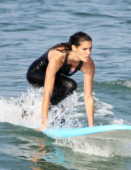 With her athletic body and Dark brown hairtype without bra (cup size 36B) on the beach in bikini
