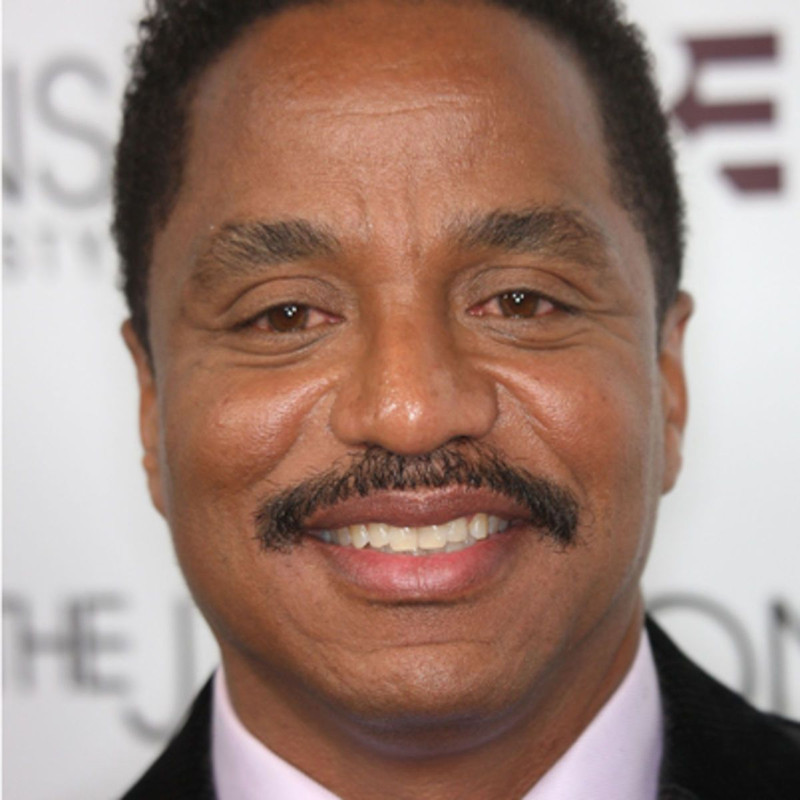 Marlon Jackson  - 2024 Dark brown hair & chic hair style.
