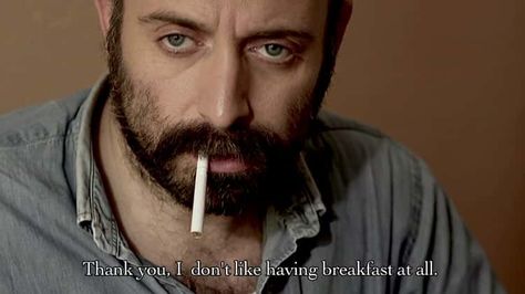 Halit Ergenç smoking a cigarette (or weed)
