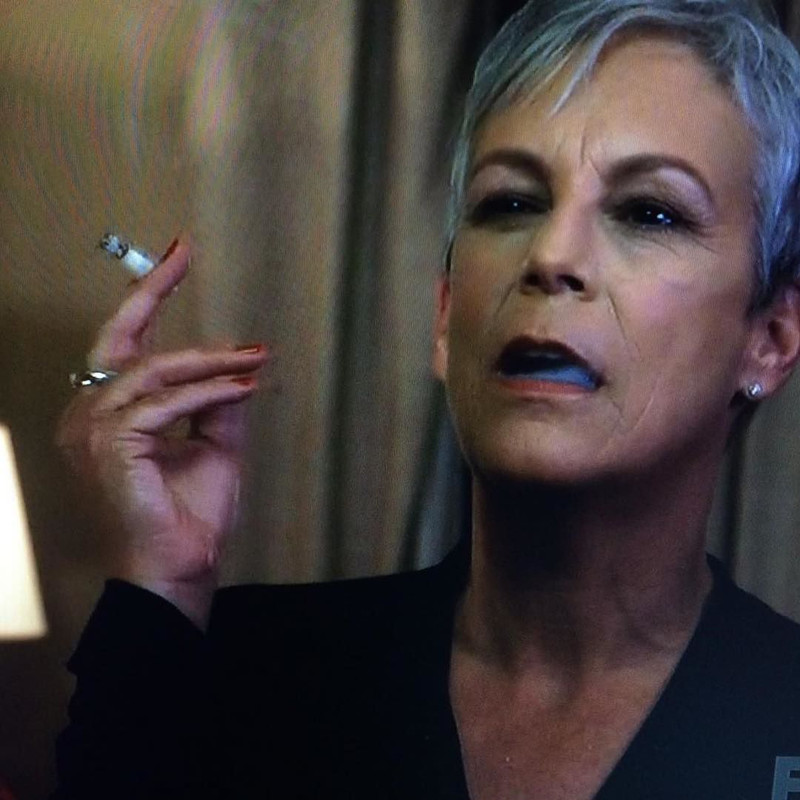 Jamie Lee Curtis smoking a cigarette (or weed)
