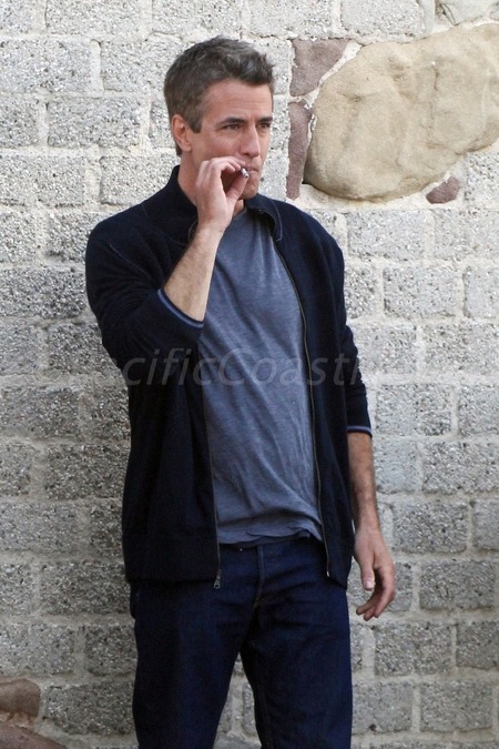 Dermot Mulroney smoking a cigarette (or weed)
