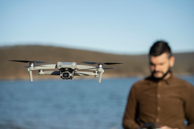 medium-shot-blurry-man-with-drone-outdoors_23-2149392704