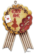 Cookie badge which features "Eat me", Alice, ace of hearts, and a golden key dipped in red.