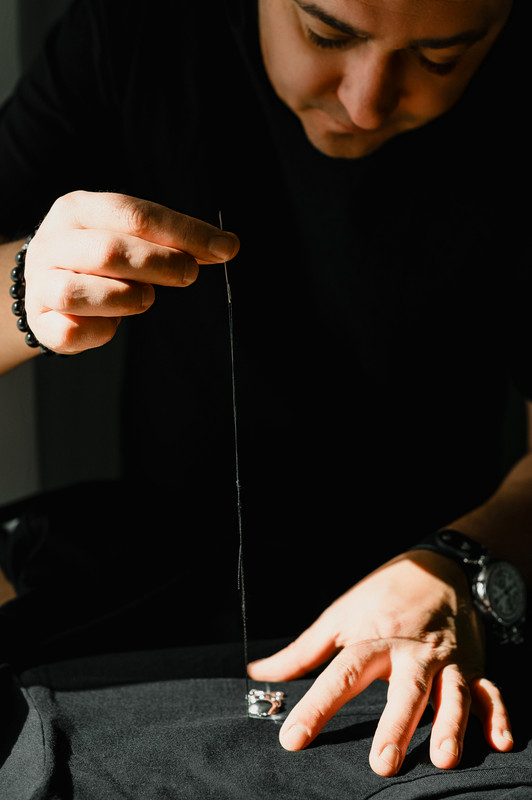 Crafting black apparel — needle and thread