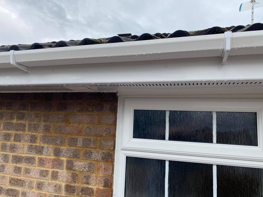 Gutter clearing in progress by a Lynx team member