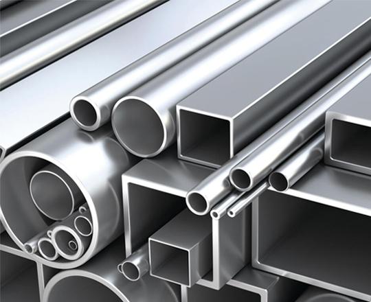 Stacked aluminium flat bars and rods in a warehouse