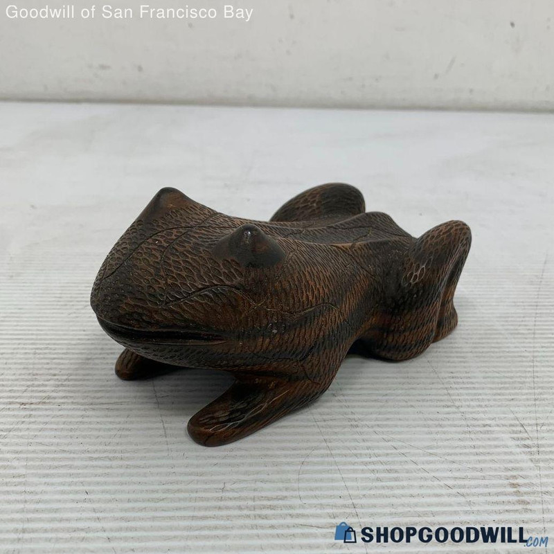 a product photo of a frog carved from dark brown wood