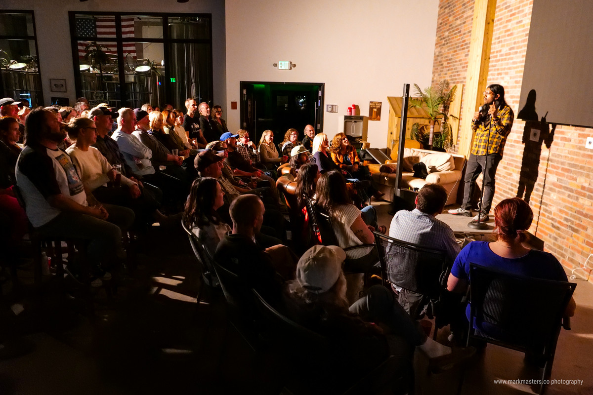 Divendra Seeram, the writer of this blog, performs stand-up comedy to crowd of people.