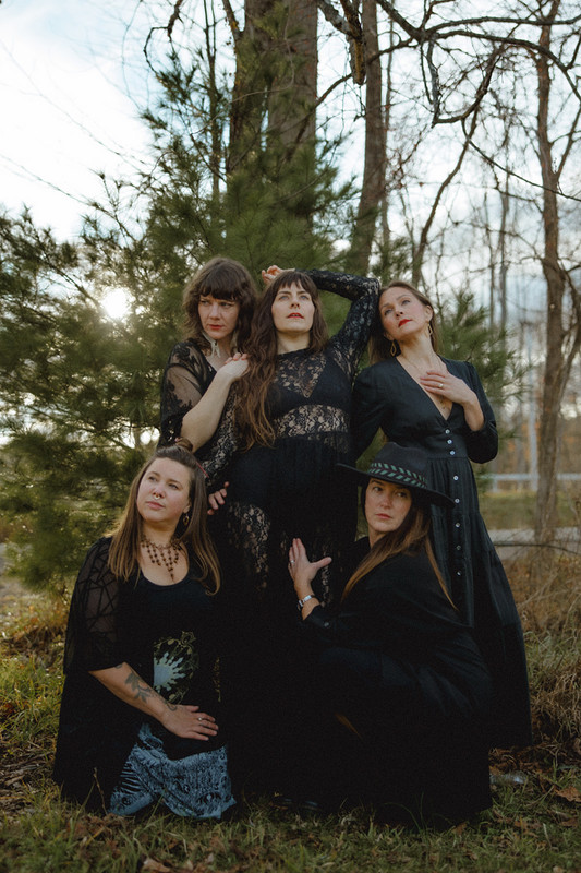 Coven walking through the field
