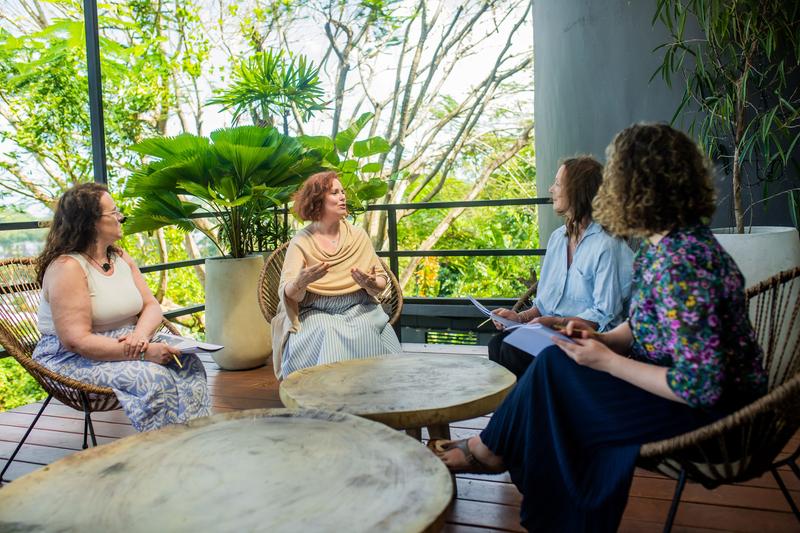 Women sitting together in a candlelit circle