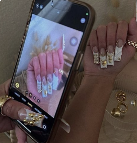 Woman checking her phone with fresh manicure