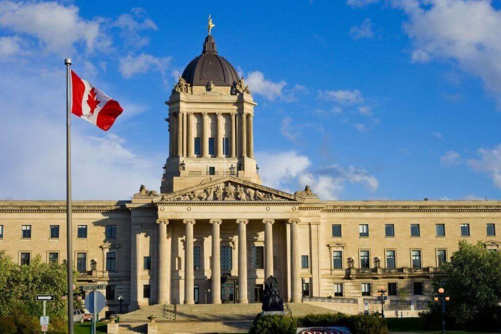 Canadian flag flying outside a government building