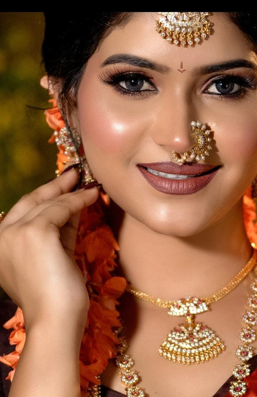 Bridal makeup close-up with traditional gold jewellery