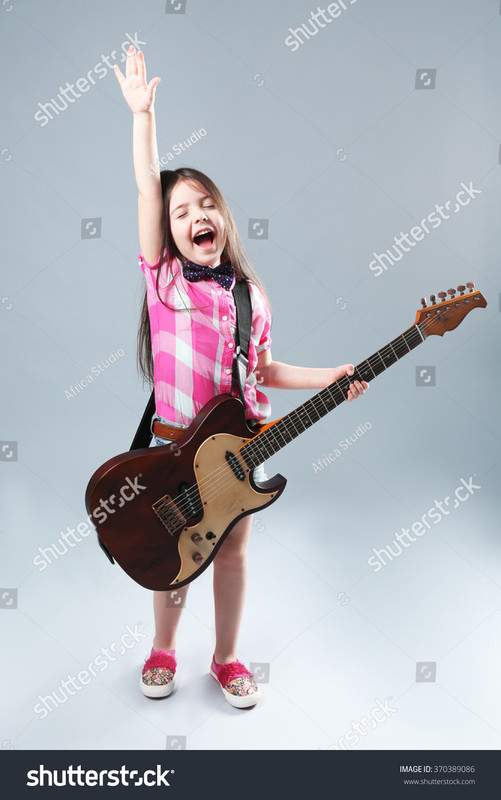 stock-photo-beautiful-artistic-little-girl-playing-guitar-on-gre