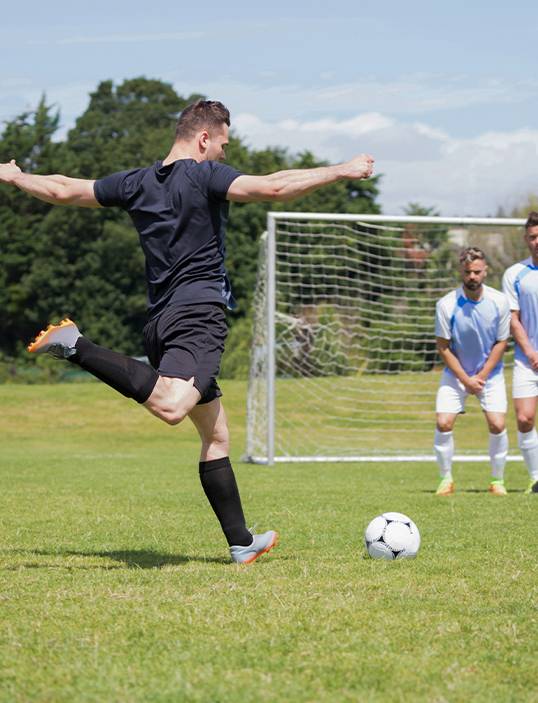 Coach Mentoring Young Players on the Pitch
