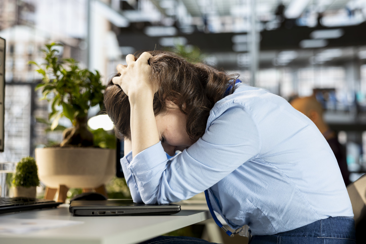general director sits her workstation frustrated overwhelmed