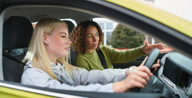 Instructor teaching a learner during a driving lesson
