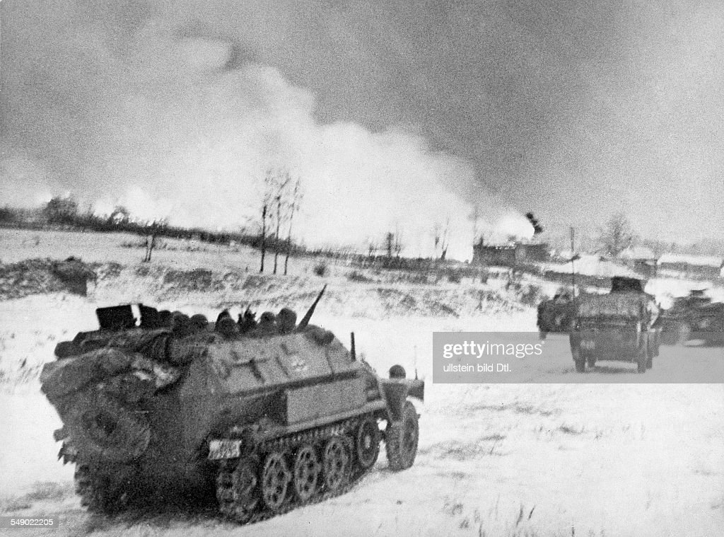 German APC 's (sdkfz 251) advancing towards a settlement. no further information early 1942