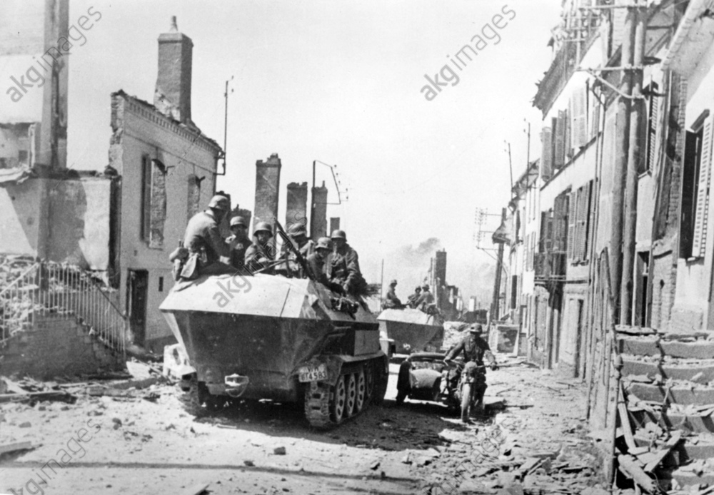 Deutschen Wehrmacht zwischen zerstörten Häusern beim Durchqueren des französischen Breteuil (Oise) n