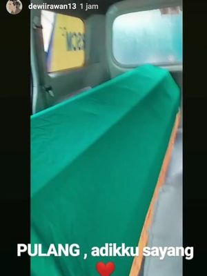 Kakak kandung Ria, Dewi Irawan mengunggah foto keranda milik Ria yang tampak berada di dalam mobil ambulans.