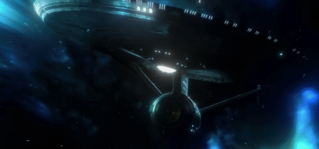 a gif of the USS enterprise, first seen mid-warp as the camera follows it, before the ship outruns the camera and disappears in the distance