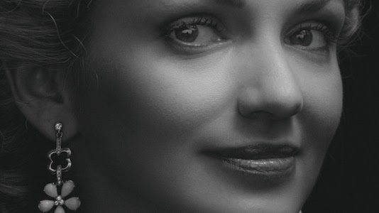 A black and white picture of a smiling girl