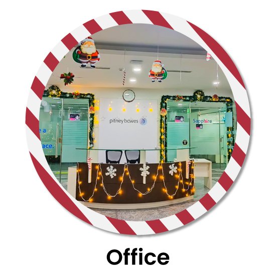 Office reception transformed for Christmas with lights, xmas tinsel garlands, and hanging santa cutouts