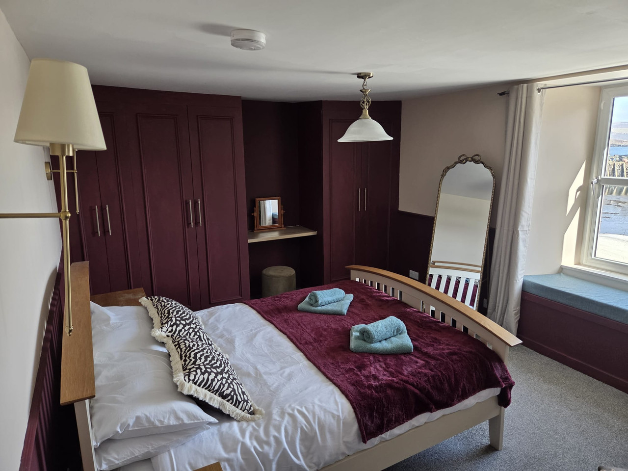 King bedroom with statement mirror