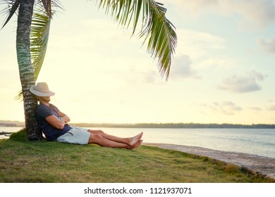 tropical vacation young man resting 260nw 1121937071