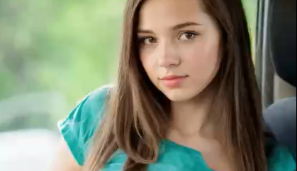 She’s lifting her shirt to flash her big boobs and pussy.