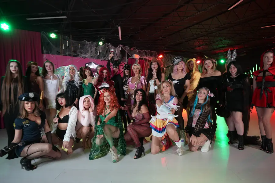 A big group photo of everyone in costume on the dance floor