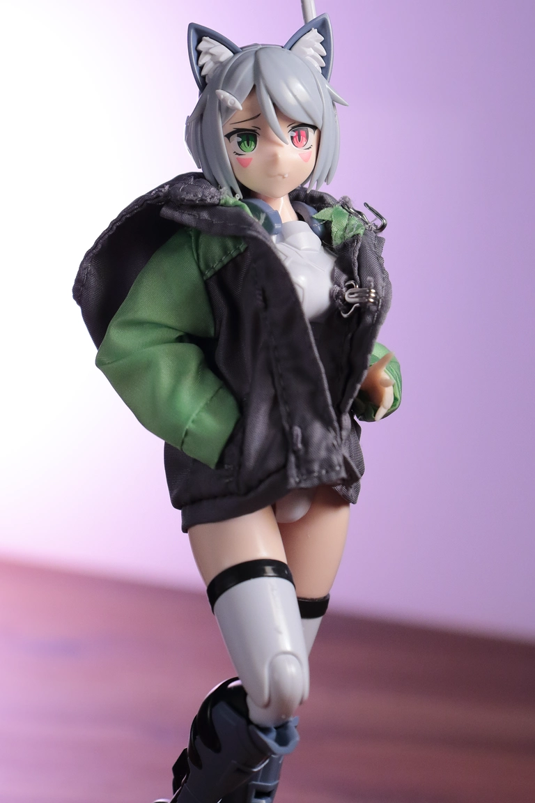 A front view of “Variable Fighter Girls” Kairos girl wearing the parka from a 1/12 Mountain Parka & Short Pants Set in gray and lime