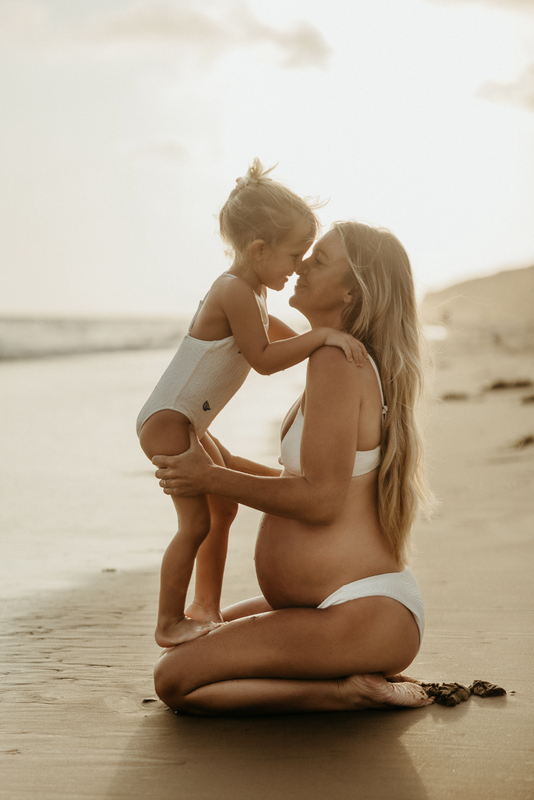 Ev with her daughter on the beach