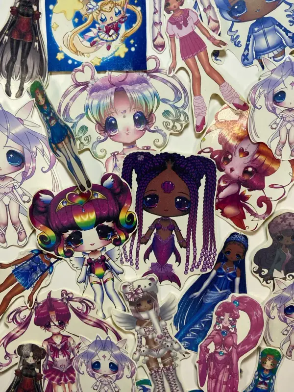 Photograph of a pile of my stickers. All are of my artwork.