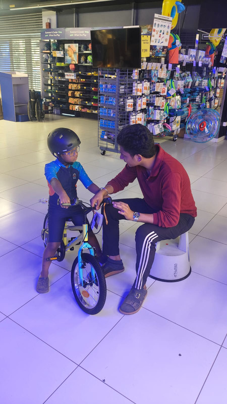 Kids learning basic bicycle safety drills under professional training