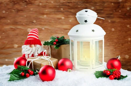 119329061-christmas-lantern-with-gifts-colored-balls-on-a-winter-wood-background-christmas-backgroun.webp