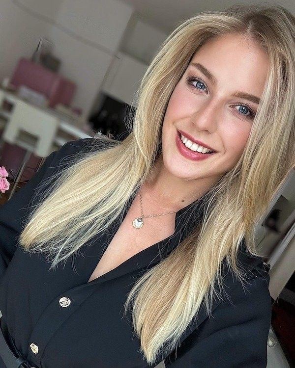Long straight honey blonde hair on a girl with a smile