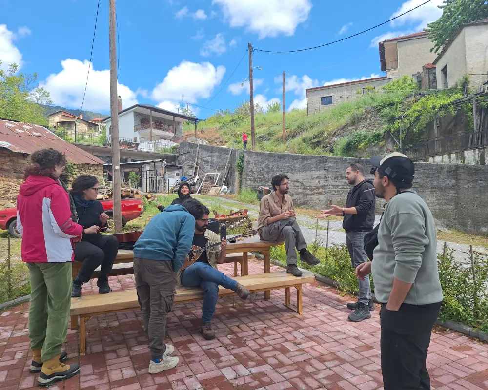 Everyone gathered around a bench chilling and playing music
