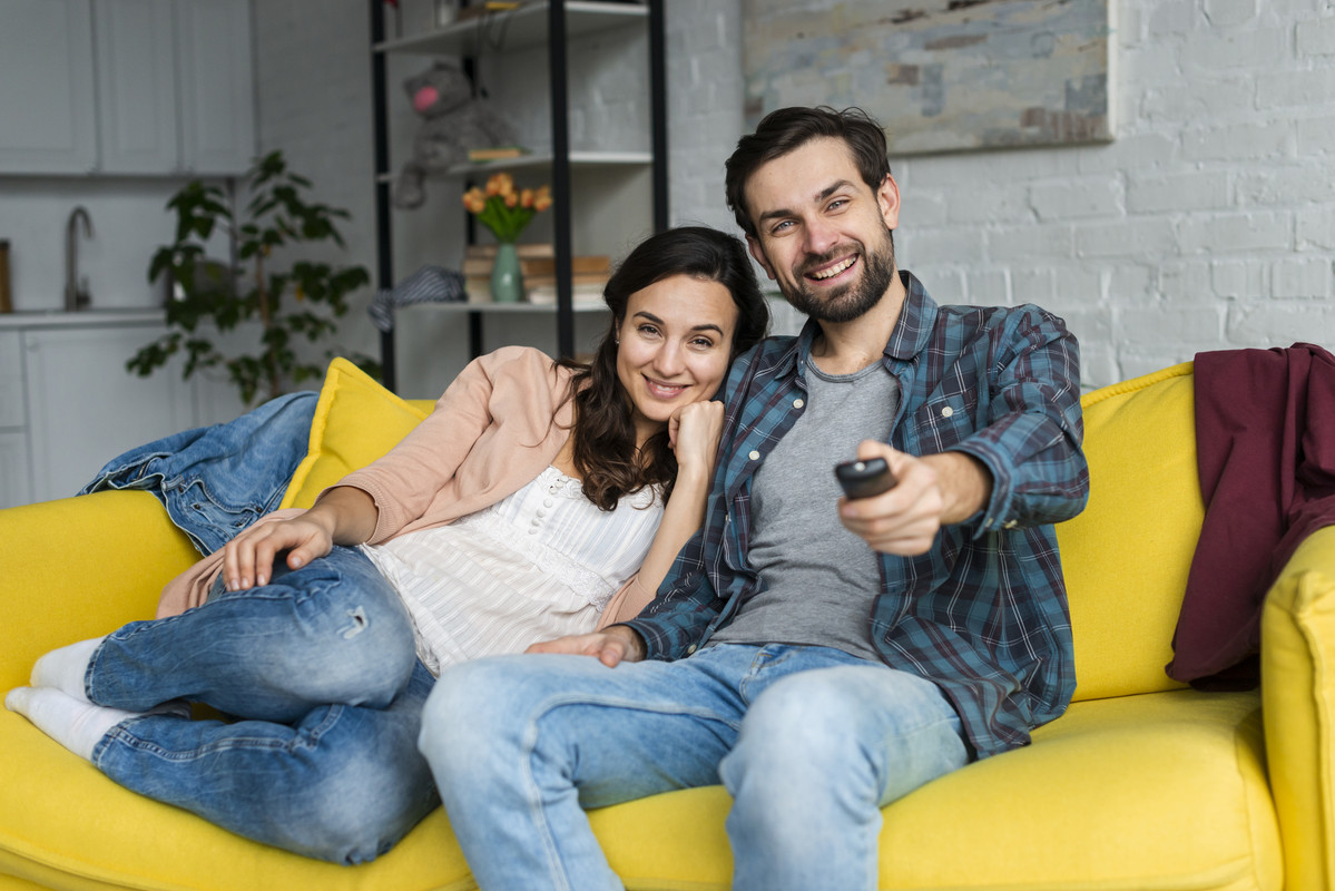 happy-couple-looking-television.jpg