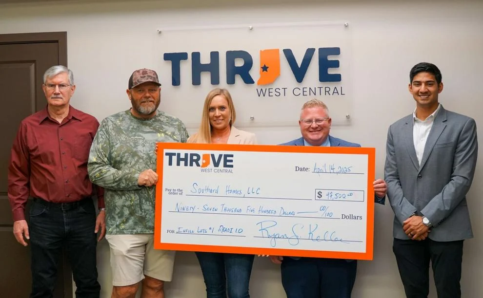 A group of people, consisting of Southard Homes, Thrive West Central, the City of Terre Haute, and other organizations, stand for a group photo holding a large check.