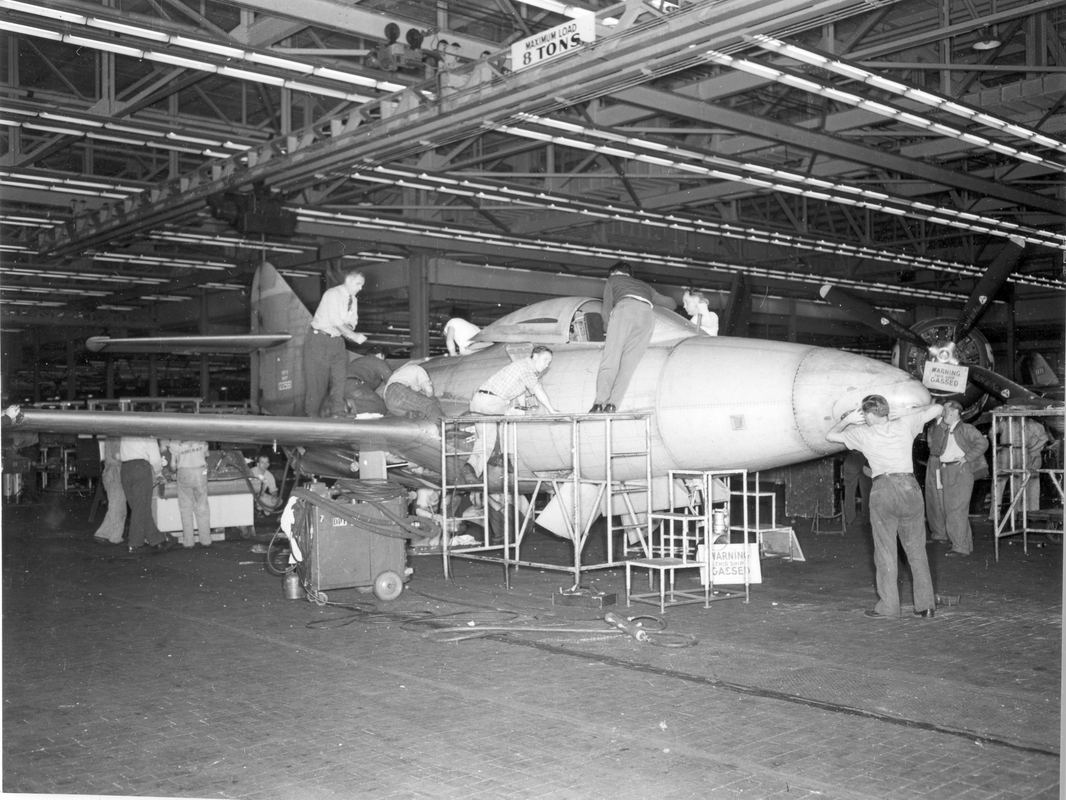 grum 980 F9F-2 shop, men working on plane, 1950s