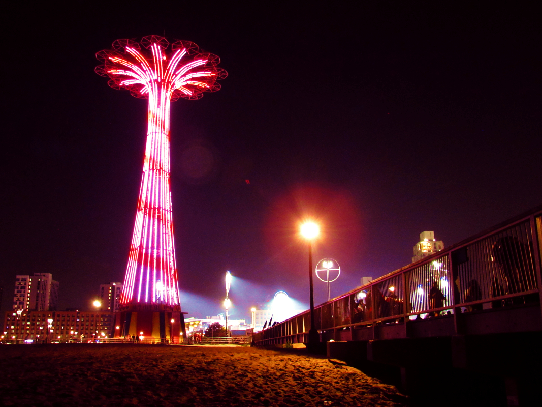 a photograph of coney island beach at night