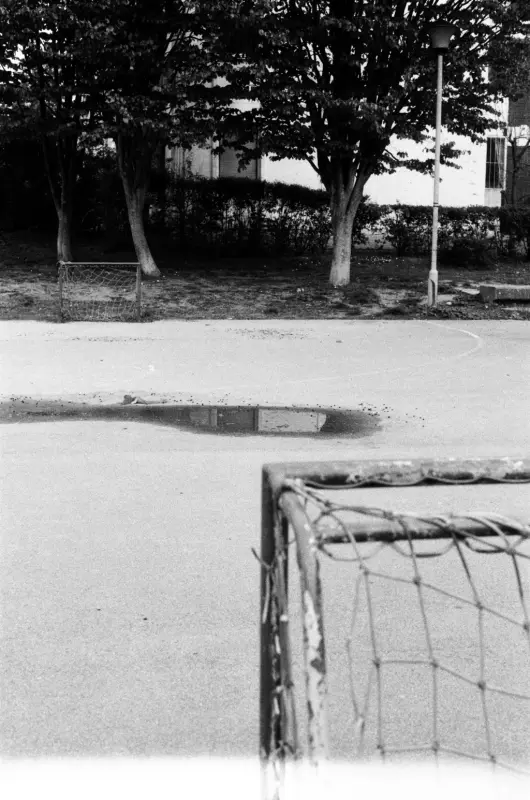 a small puddle in the middle of kids' football pitch.