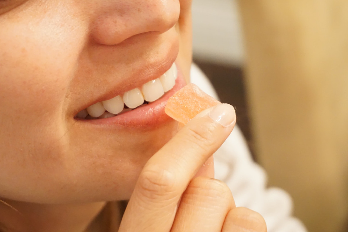 Woman taking CBD Gummies